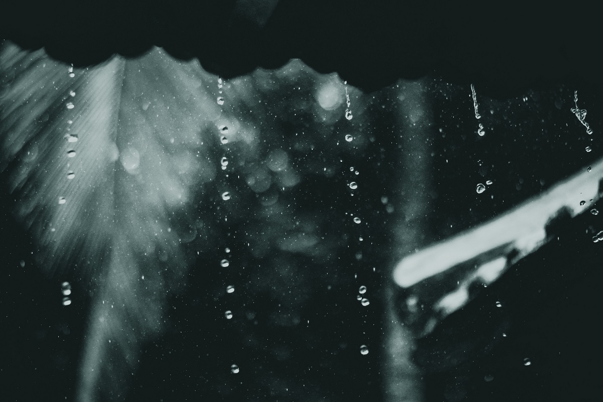 Image of raindrops falling from a roof